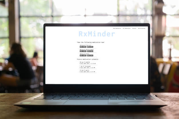 RxMinder app built with React as seen on laptop in coffee shop